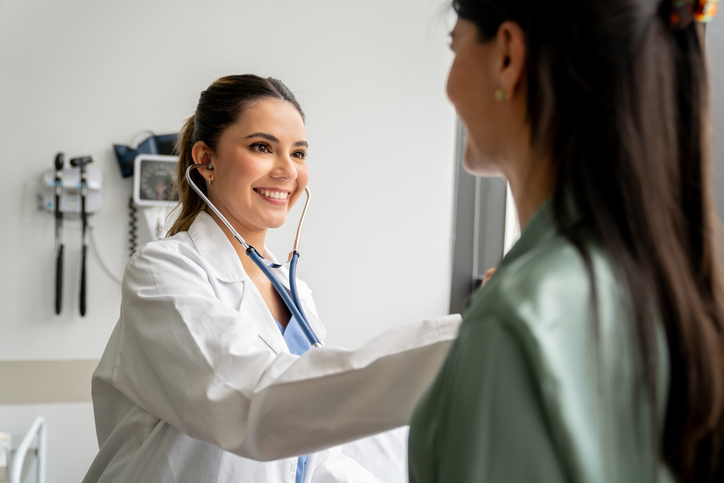 female dotor checking heart beat 