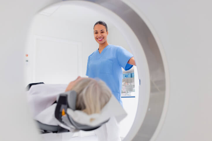  Nurse smiling while patient undergoes mri scan